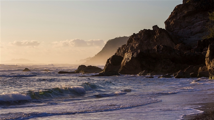 Waves crashing on a rocky coastline at dawn