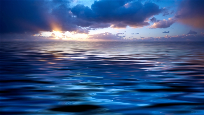 Sunset over the ocean with dramatic clouds