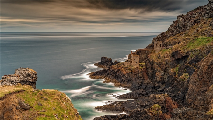 Ruined buildings on a rocky coast overlooking the sea