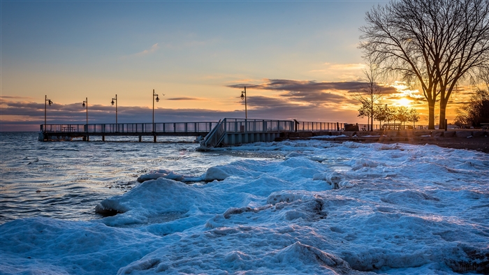 Pier and icy shore at sunset in Ontario, Canada 4K