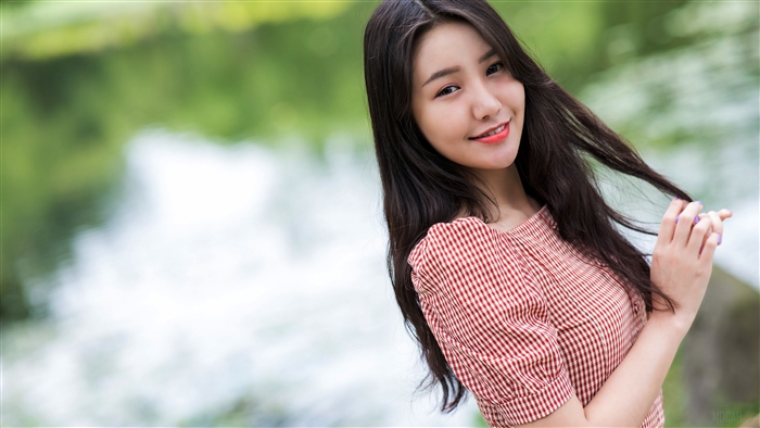 Asian woman with long black hair and red dress