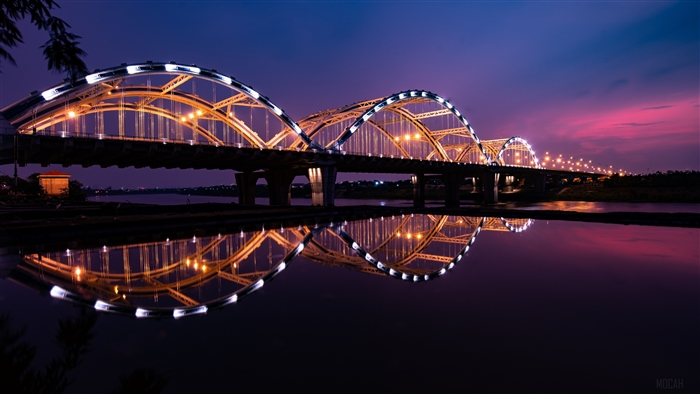 Bridge illuminated at night with reflection in Vietnam 4K