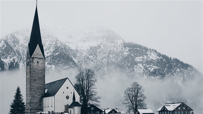 Church in a Snowy Village with Mountains