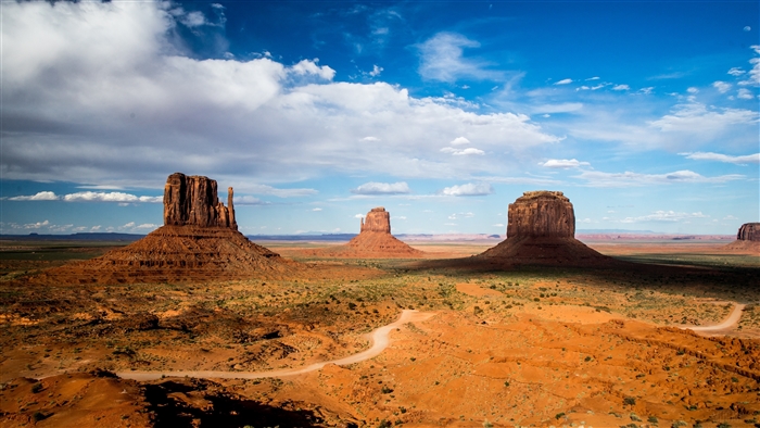 Monument Valley desert landscape with rock formations and clouds