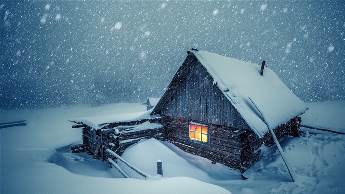 Snow-covered Cabin with Warm Light at Night