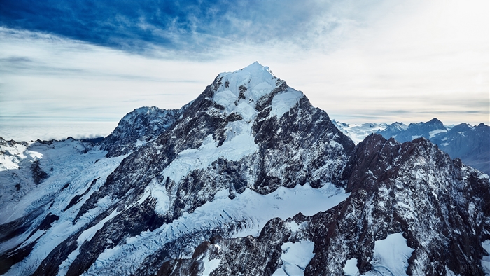 Snow-covered mountain peak under a blue sky