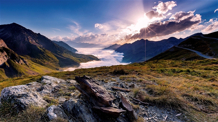 Mountain landscape with clouds and sun rays