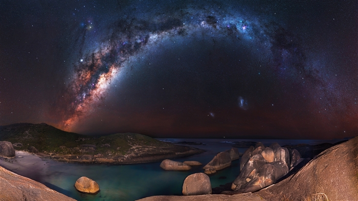 Milky Way over a rocky coastline at night 4K