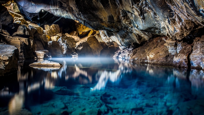 Cave with Blue Water and Rock Formations 4K