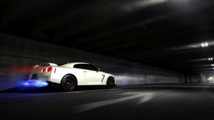 White Nissan GTR with flames in tunnel