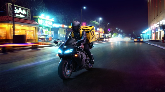 Delivery boy on a motorcycle at night