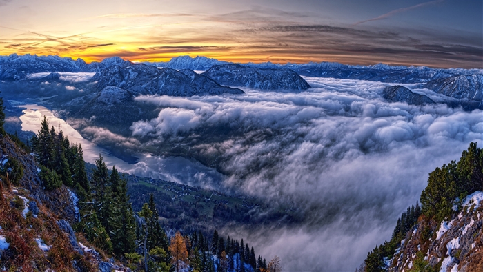 Mountain landscape with clouds and lake at sunset