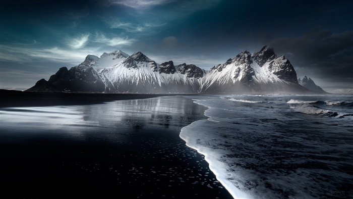 Snow-capped mountains on a black sand beach in Hofn, Austurland, 4K