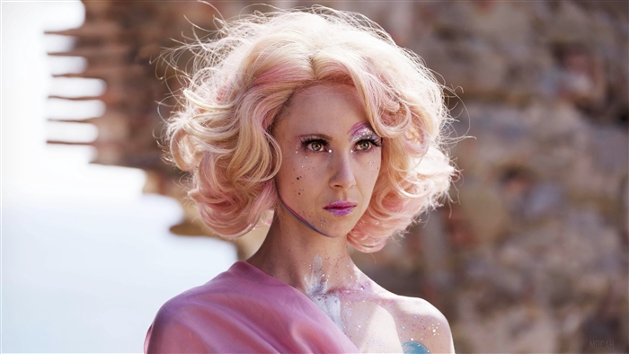Woman with pink hair and glitter makeup