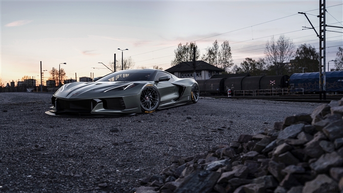 Gray 2020 Corvette C8 on gravel near train tracks