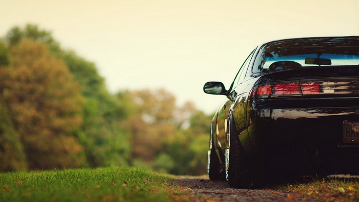 Black Nissan Silvia S14 parked on a dirt road