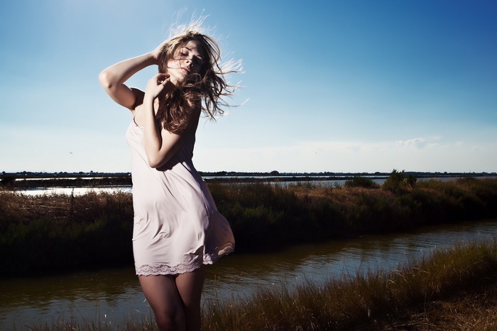 Woman in slip dress by water