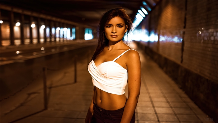 Woman in white top in dark tunnel