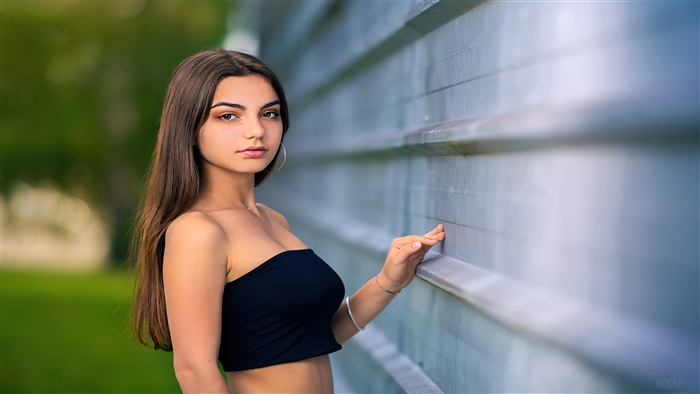 Girl posing by a corrugated wall