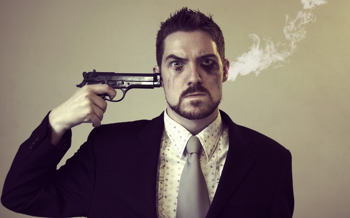 Man in Suit Holding Gun to Head with Smoke