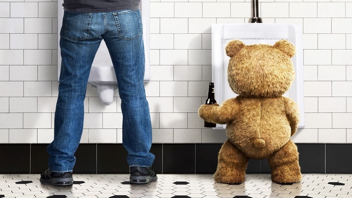 Ted from Ted holding a beer in a bathroom
