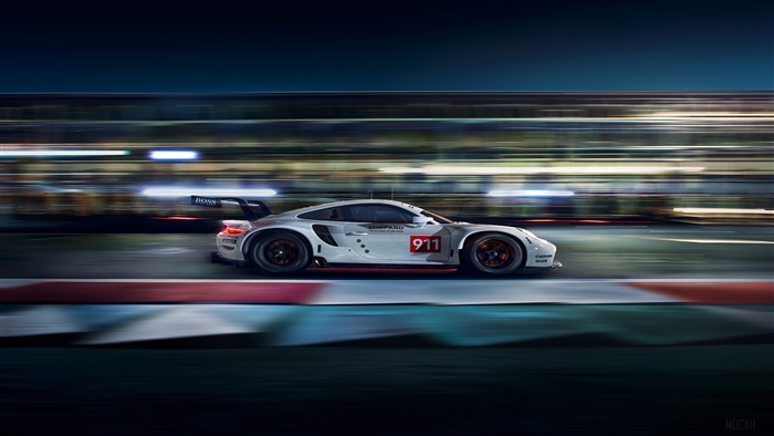 Porsche 911 RSR race car on track at night