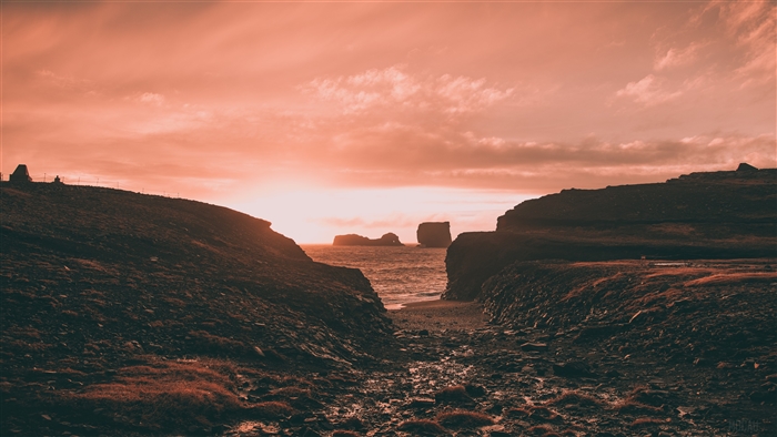 Sunset over rocky coast with sea stacks