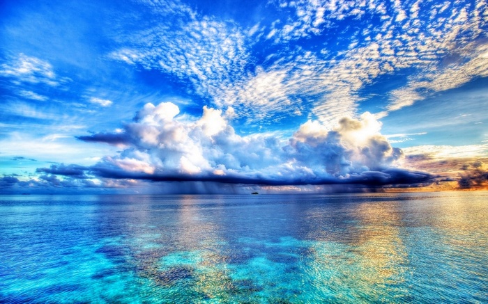 Vast ocean under a dramatic sky with clouds