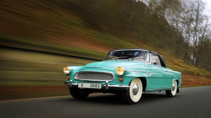 Turquoise Skoda Felicia Convertible driving on a road