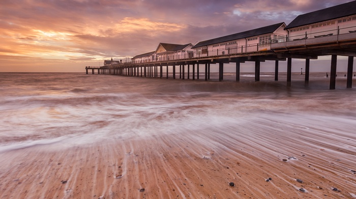 Pier over the ocean at sunset