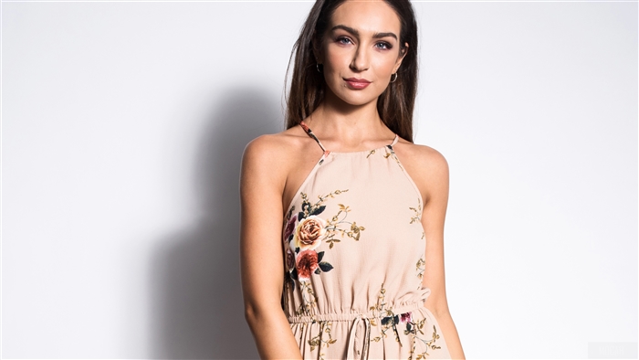 Woman in floral dress looking at viewer 4K