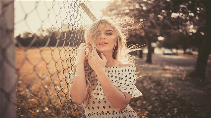 Woman Leaning On Chain Fence