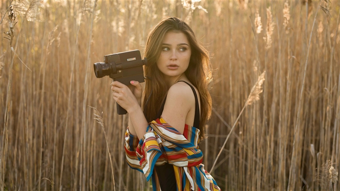 Brunette Girl Holding Vintage Camera in Field 4K