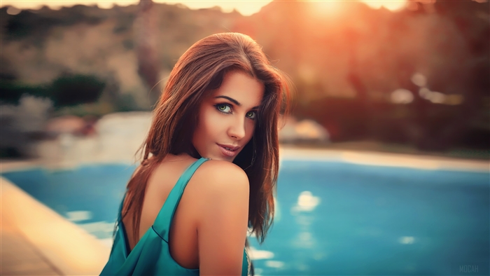 Woman with long hair by a pool