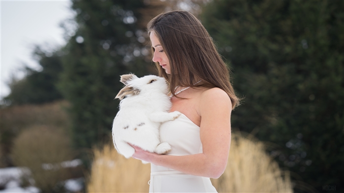 Girl holding a rabbit in winter