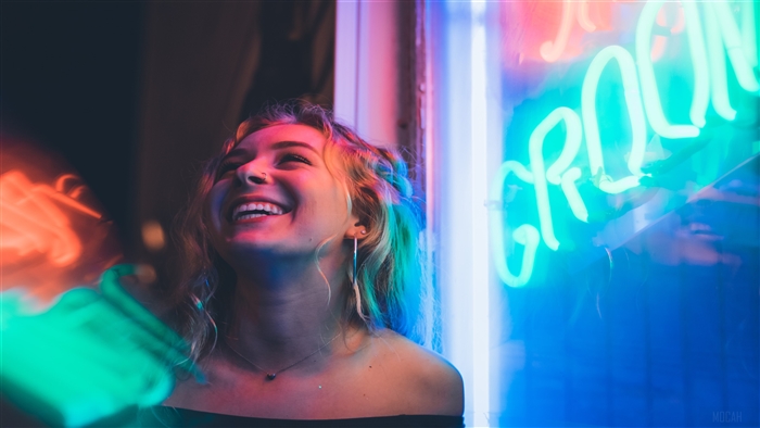 Woman smiling near neon lights 4K