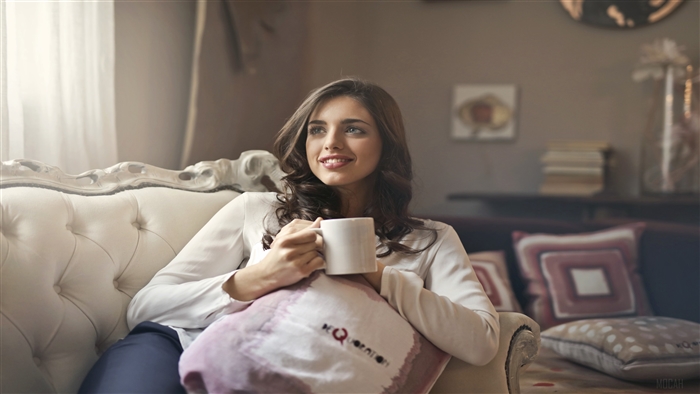 Woman Sitting on Couch with Mug 4K