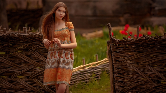 Girl with long hair in a patterned dress
