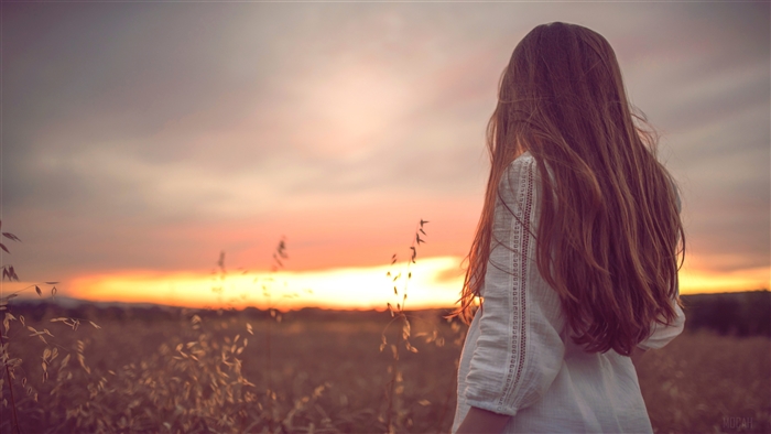 Girl in a field at sunset 4K