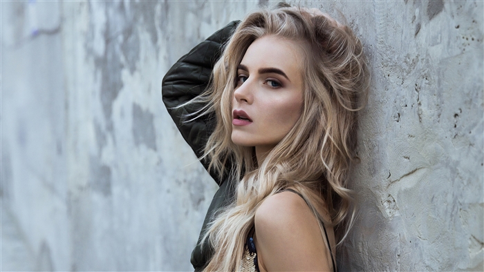 Model posing against a concrete wall