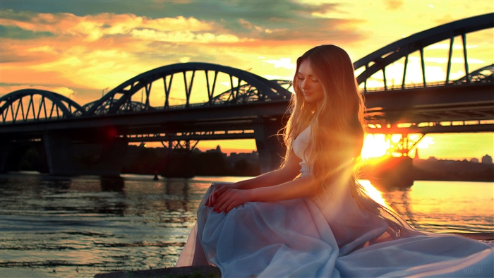Girl sitting on bridge side at sunset 4K