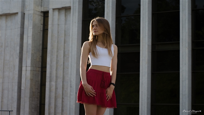 Girl in red skirt and white top outdoors 4K