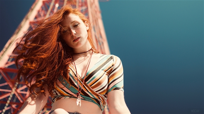 Young woman with red hair on a sunny day