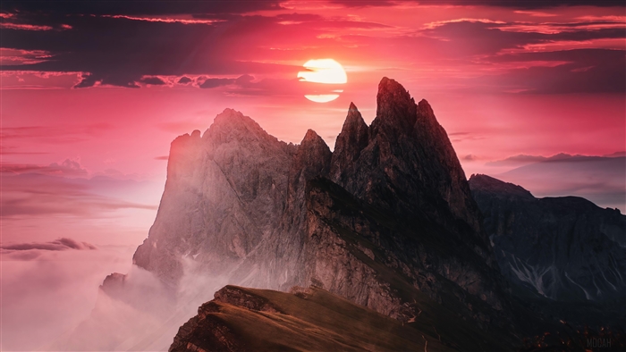 Sunset over jagged mountain peaks