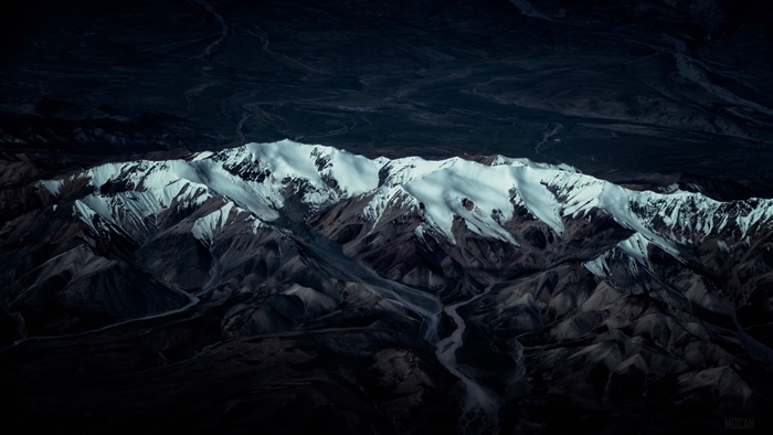 Snow-capped mountain range with river valley