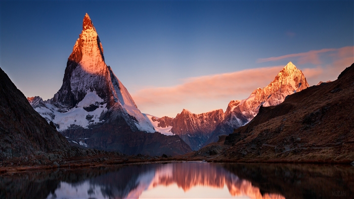 Matterhorn mountain at sunrise reflected in a lake