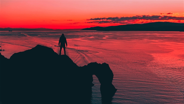 Man Standing on Cliff During Sunset 4K