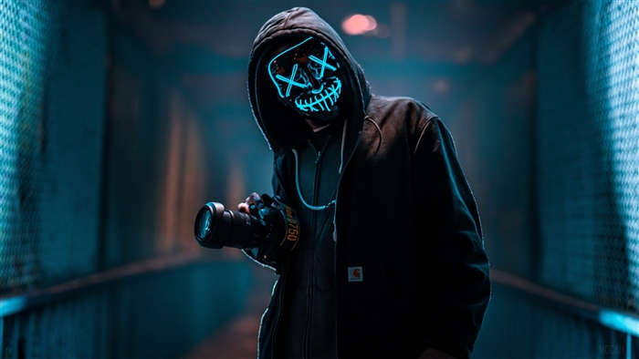 Masked person with DSLR camera