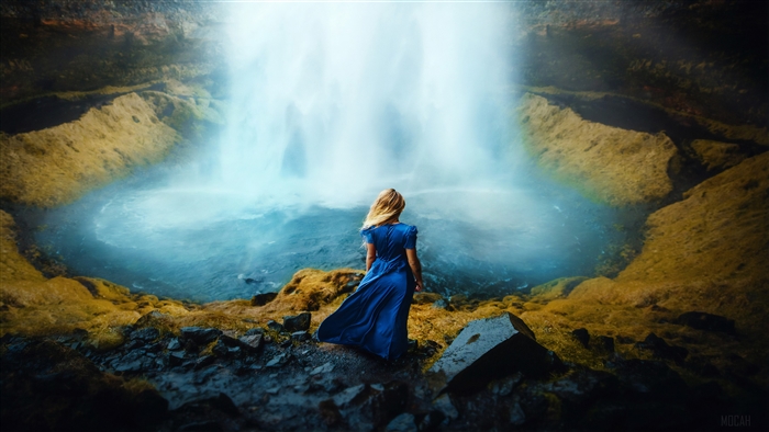 Woman in blue dress at waterfall 4K