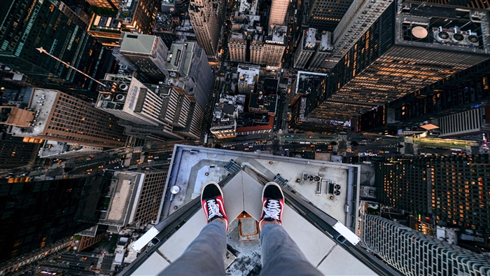 Person standing on a skyscraper in New York City 4K